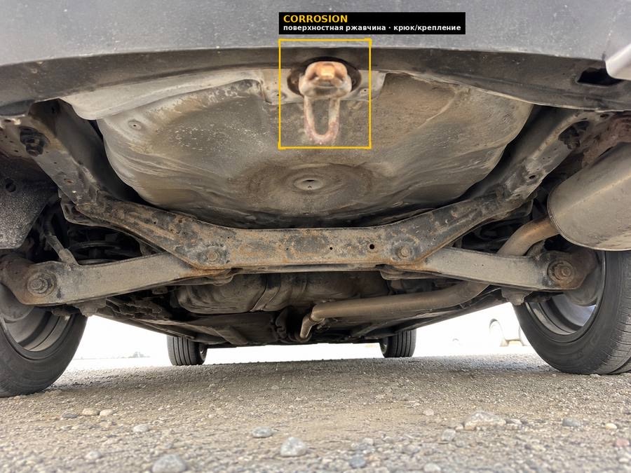 Underbody scan: surface rust on the tow hook mount
